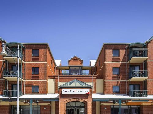 a red brick building with a sign in front of it at BreakFree Adelaide in Adelaide