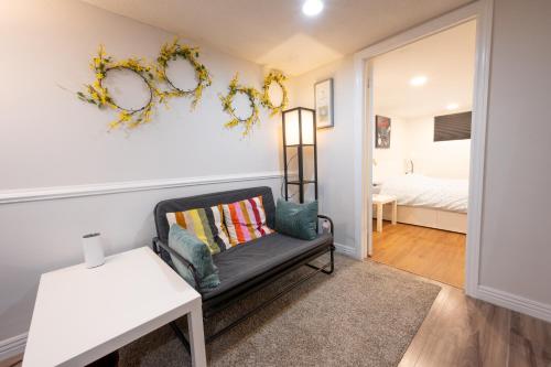 a living room with a couch and a bed at Comfy Private Basement- Scarborough in Toronto