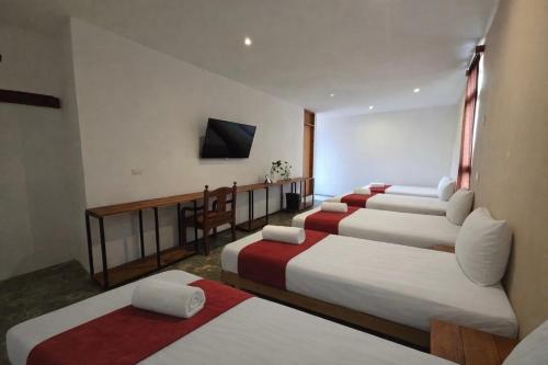 a group of four beds in a room at Hotel VSI in Playa del Carmen