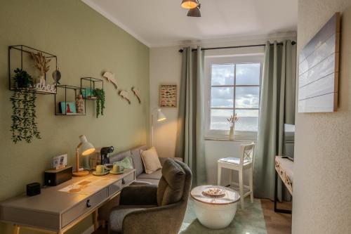 a home office with a desk and a window at AKZENT Strandhotels Seestern, Delphin & Lachs in Wilhelmshaven