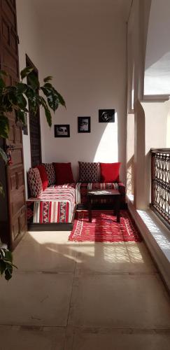 a living room with a couch and a red rug at Riad Safia in Marrakesh