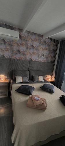 a bedroom with a large bed with a towel on it at γαληνη in Vamos