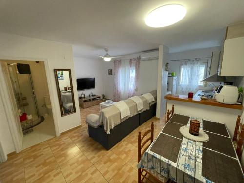 a living room with a dining room table and a living room with at La Cenia in Denia