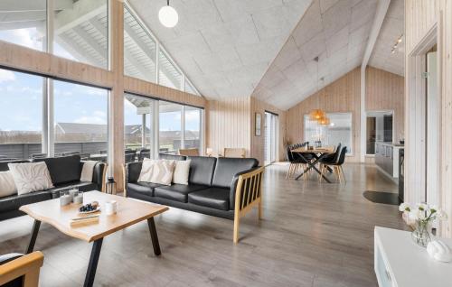 a living room with a couch and a table at Beach Front Home In Bogense With Sauna in Bogense