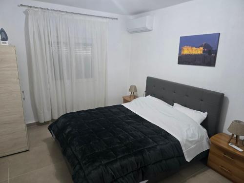a bedroom with a large bed and a window at uncie spiros house in Nea Fokea