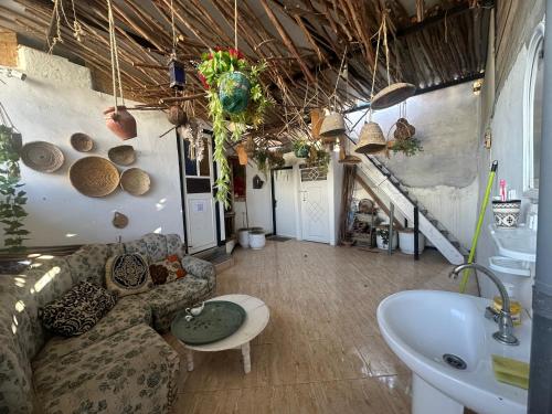 a living room with a couch and a sink at The Trizit in Taghazout