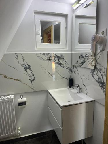 a bathroom with a sink and a mirror at La TRIUNGHIURI in Târgu Ocna