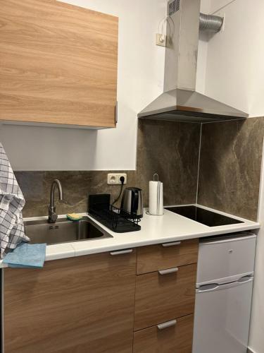 a kitchen with a sink and a stove at Chambre double à Niederkorn in Differdange
