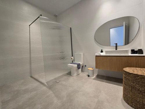 a bathroom with a shower and a toilet and a sink at Ilia Suites "Thalassa" in Ilia