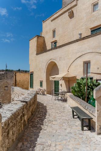 a building with a bench in front of it at Palazzo Del Duca Hotel & Restaurant in Matera