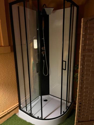 a shower with a glass enclosure in a room at Agréable maison avec SPA in Crécy-en-Ponthieu