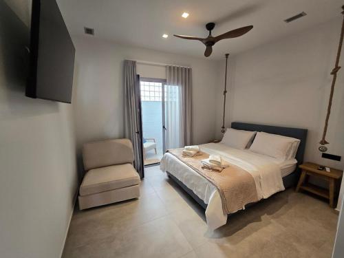 a bedroom with a bed and a ceiling fan at Ilia Suites "Thalassa" in Ilia