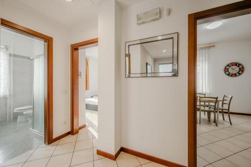 a hallway with a mirror and a dining room at Hotel Nuova Barcaccia in Peschiera del Garda