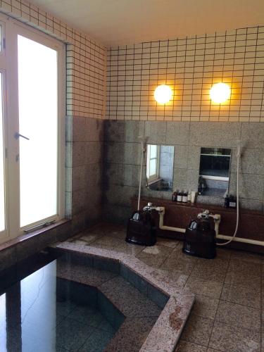 a bathroom with a sink and a large mirror at Muikamachi Hutte in Minami Uonuma