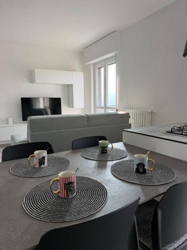 a living room with a table with coffee mugs on it at Lake at Home in Lecco