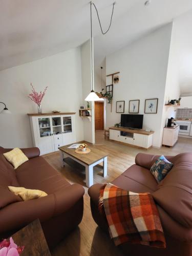 a living room with two couches and a coffee table at Haus Teelke in Papenburg