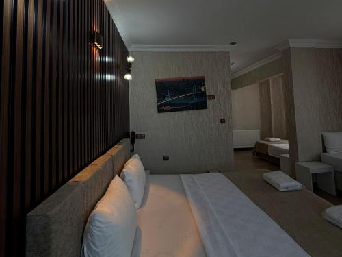 a hotel room with a large bed and a couch at Koc Hotel in Karasu