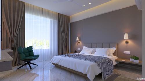 a bedroom with a large bed and a green chair at Hotel Sanskar Elite By Keshav Global in Jaipur