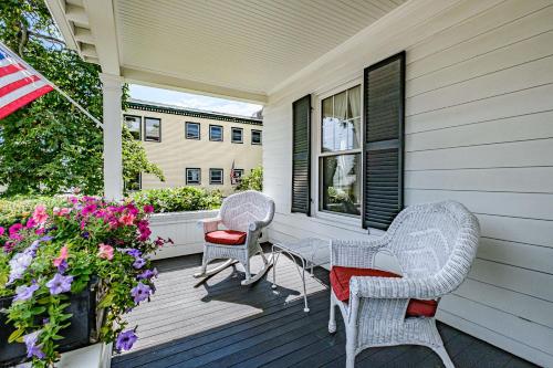three wicker chairs and a table on a porch at The Nicholson Inn in Freeport