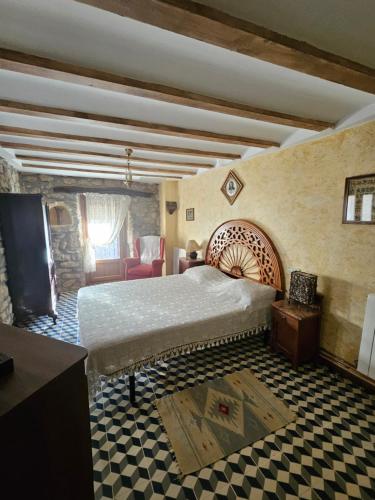 a bedroom with a large bed and a living room at Casa de la Gallega in Bargota