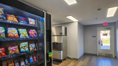 a vending machine filled with lots of different types of chips at SureStay by Best Western Sacramento South Natomas in Sacramento