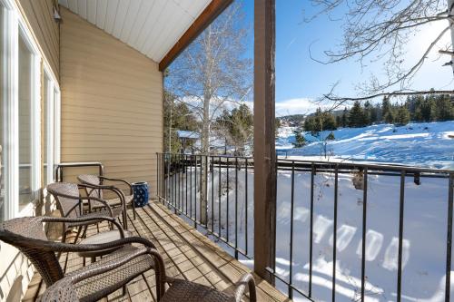 a balcony with chairs and a view of the snow at Mountainside Unit B-20 in Granby