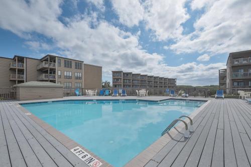 a large swimming pool with a wooden deck at 2973 - The Shack in Duck