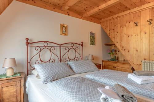 a bedroom with a large bed in a room with wooden walls at Private Veranda - Tiroler Chalet - Near Ski Slopes & Dolomites in Carano