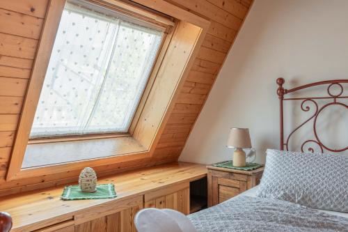 a bedroom with a bed and a large window at Private Veranda - Tiroler Chalet - Near Ski Slopes & Dolomites in Carano