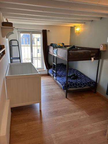 a room with two bunk beds and a window at La Fabrique - Relaxing break with Jacuzzi in Crécy-en-Ponthieu