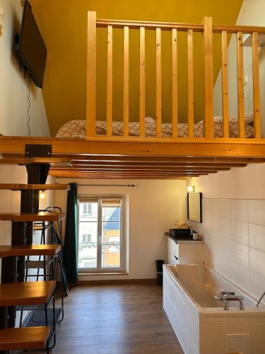 a small room with a bunk bed and a sink at La Fabrique - Relaxing break with Jacuzzi in Crécy-en-Ponthieu
