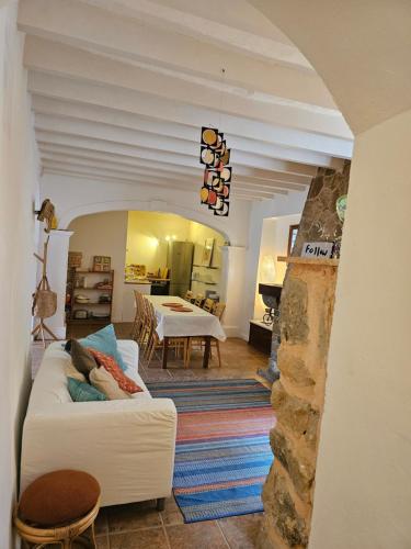 a living room with a white couch and a table at Agroturismo Finca Can Sec in Alaró