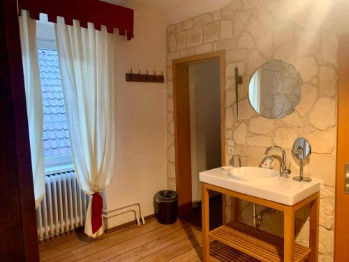 a bathroom with a sink and a window at Gasthof Sonne in Schiltach