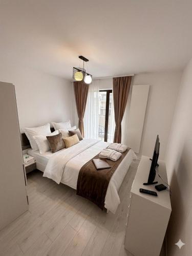 a bedroom with a bed and a desk with a computer at Cloud 9 Bucharest Residence in Bucharest