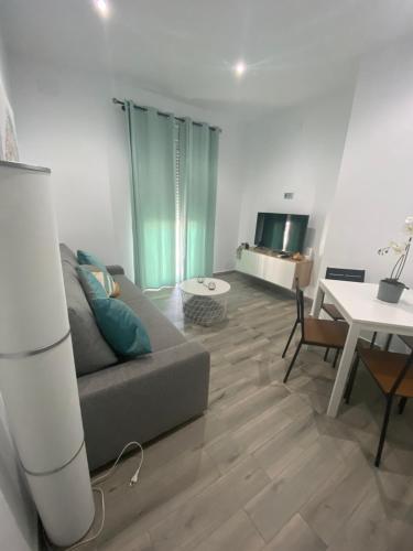 a living room with a couch and a table at Casa Monturrio in Moguer