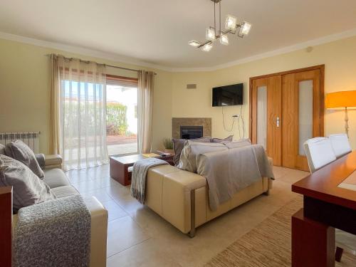 a living room with a bed and a couch at Cozy & Calm Beach House in Ovar