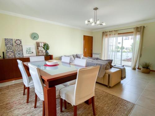 a living room with a table and a couch at Cozy & Calm Beach House in Ovar