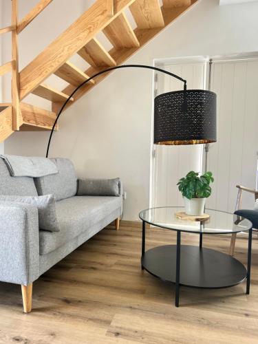 a living room with a couch and a table at Villa Ribeirinho Stays - 4 Bedrooms in Porto