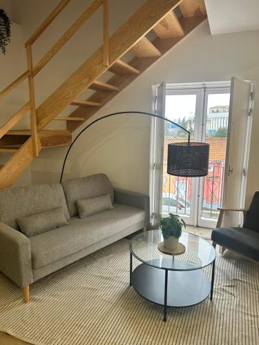 a living room with a couch and a glass table at Villa Ribeirinho Stays - 4 Bedrooms in Porto