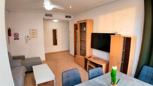 a living room with a couch and a television at Apartalux San Pedro Playa in San Pedro del Pinatar