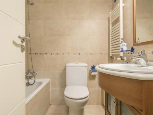 a bathroom with a toilet and a sink at Terraza Varellas in Latas