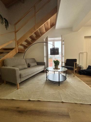 a living room with a couch and a table at Villa Ribeirinho Stays - 4 Bedrooms in Porto