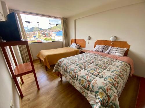 a hotel room with a bed and a window at Nayras Puno Hotel in Puno