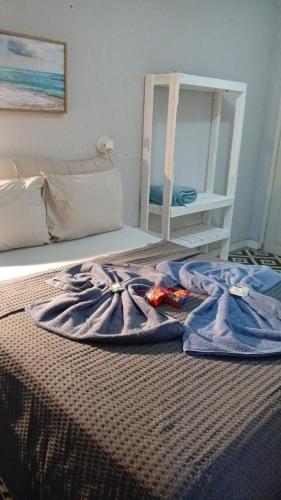 a blanket on a bed in a room at Lotf Privativo in Volta Redonda