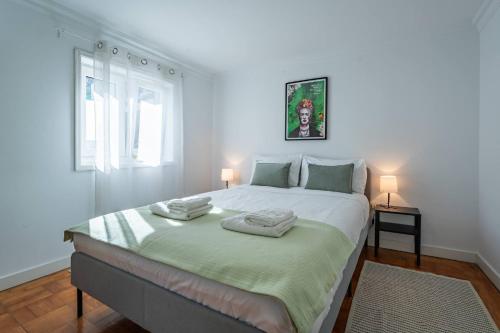 a bedroom with a large bed with two towels on it at Oporto Maria Pia With Terrace Suite 4 in Porto