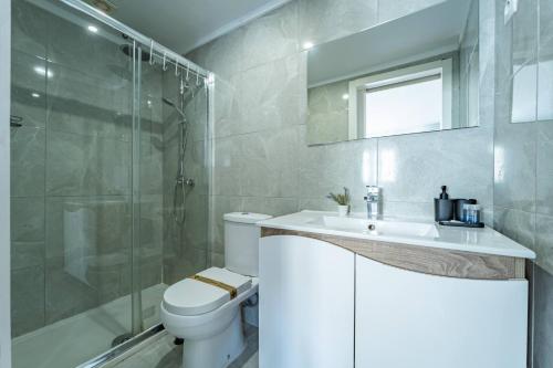a bathroom with a toilet and a sink and a shower at Oporto Maria Pia With Terrace Suite 4 in Porto