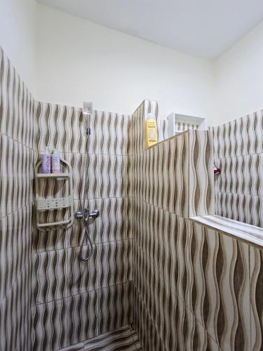 a bathroom with brown and white shower curtain at Caribbean Domicil Apartment 02 in Las Terrenas