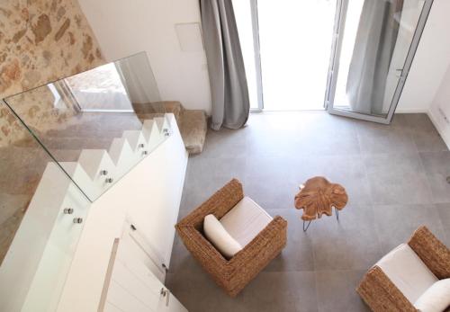 a living room with a glass table and chairs at Villa Casa Rosa in Olhão