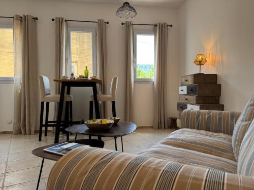 a living room with a couch and a table at La Fontaine du Soleil in Salernes