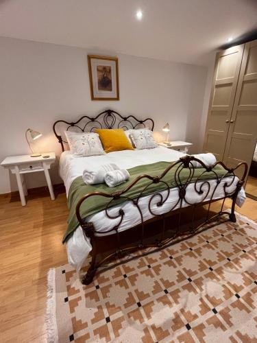 a bedroom with a large bed with yellow pillows at The Cabin at Swelle Cottages in Poundstock